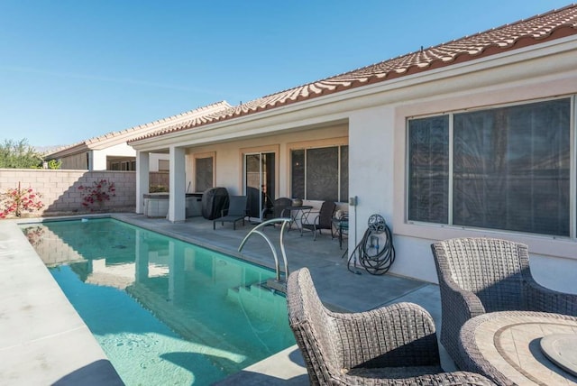 view of swimming pool featuring a patio area