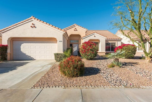 mediterranean / spanish-style home with a garage