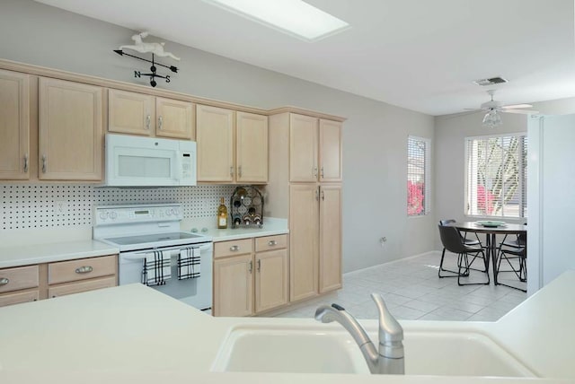 kitchen with ceiling fan, tasteful backsplash, white appliances, light brown cabinetry, and sink