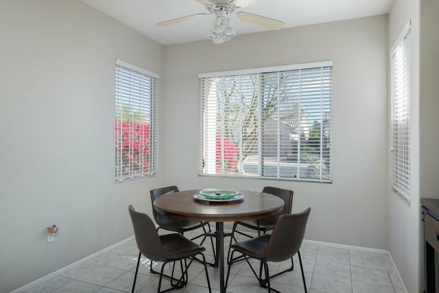 dining space featuring ceiling fan and light tile patterned floors