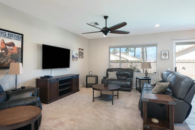 carpeted living room featuring ceiling fan