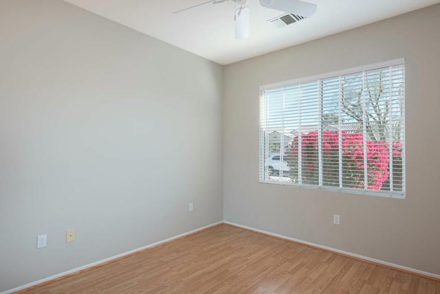 empty room with ceiling fan and light hardwood / wood-style floors