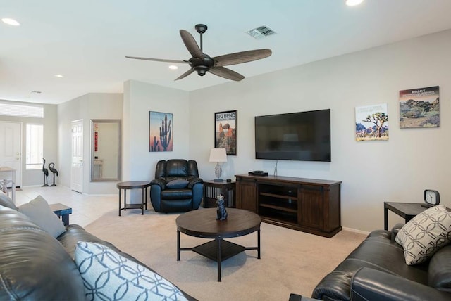 living room with ceiling fan and light colored carpet