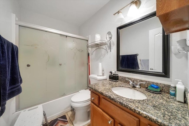 full bathroom featuring vanity, shower / bath combination with glass door, and toilet