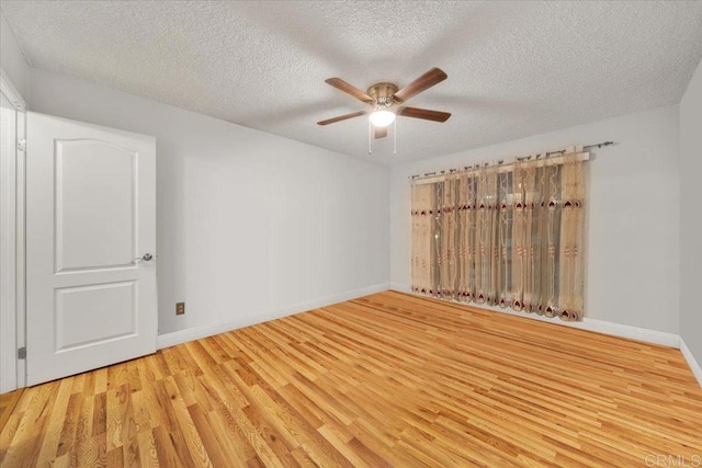 unfurnished room featuring ceiling fan, light hardwood / wood-style flooring, and a textured ceiling