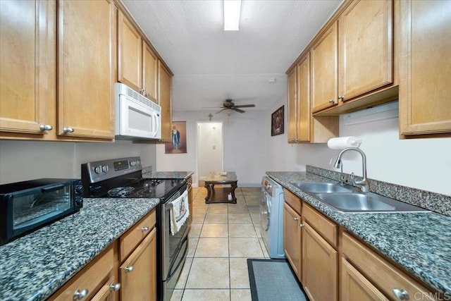 kitchen featuring light tile patterned flooring, dishwasher, sink, stainless steel range with electric stovetop, and ceiling fan