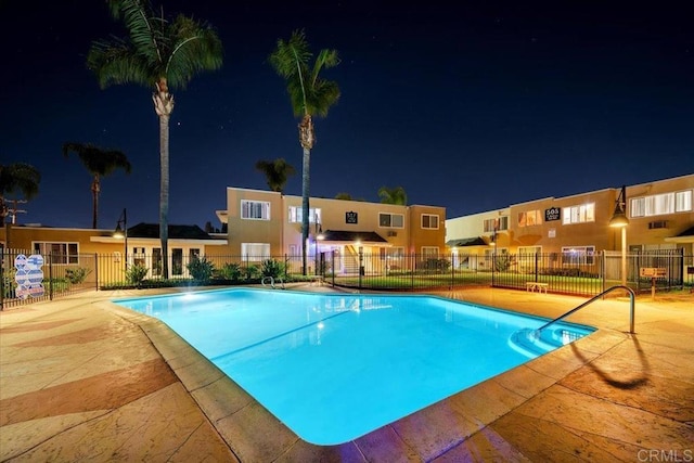 pool at twilight with a patio