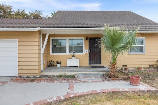 property entrance featuring a porch and a garage