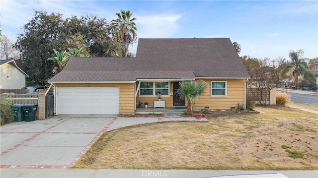 view of front of property featuring a front yard and a garage