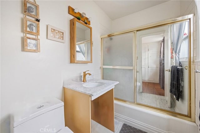 full bathroom with toilet, enclosed tub / shower combo, and vanity