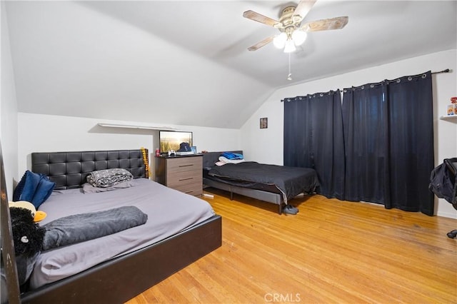 bedroom featuring ceiling fan, vaulted ceiling, and light hardwood / wood-style floors