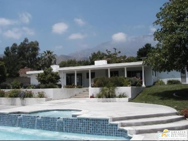 back of house with a mountain view