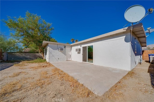 back of house featuring a wall mounted AC and a patio