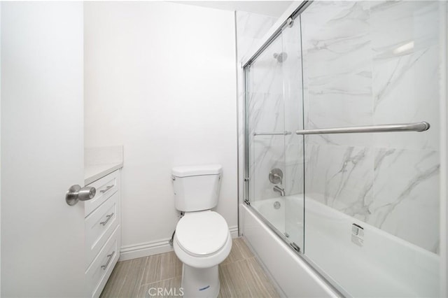 full bathroom with toilet, combined bath / shower with glass door, and vanity