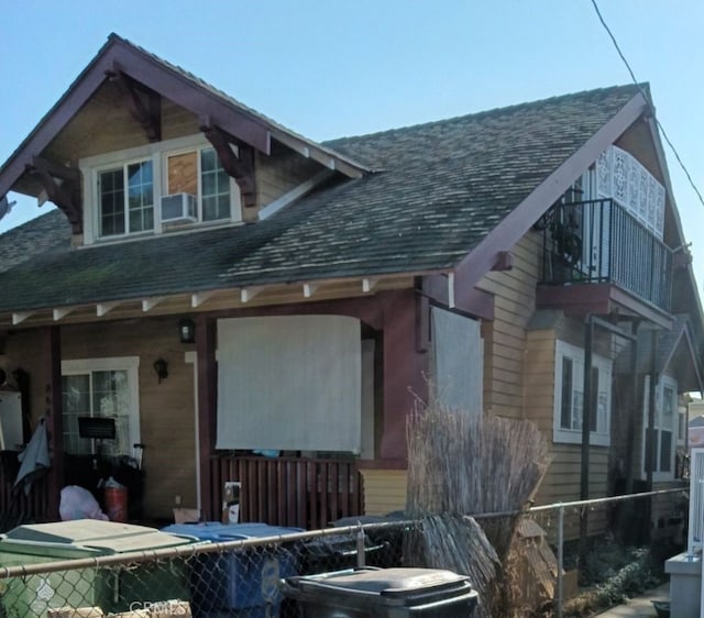 back of property with a balcony