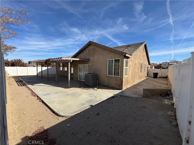 back of house with a pergola, a patio area, and central AC