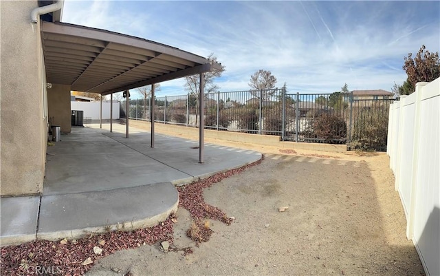 view of patio with central AC unit and a carport