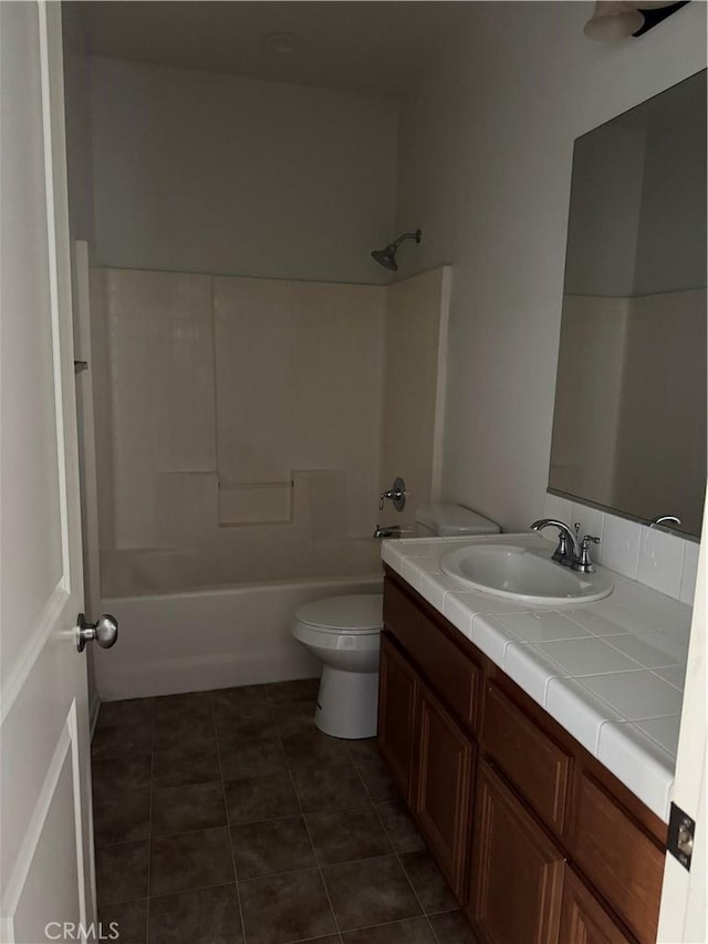 full bathroom featuring toilet, vanity, tile patterned floors, and shower / tub combination