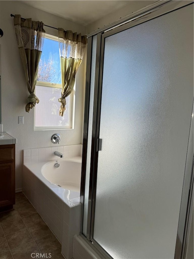 bathroom with tile patterned floors, separate shower and tub, and vanity