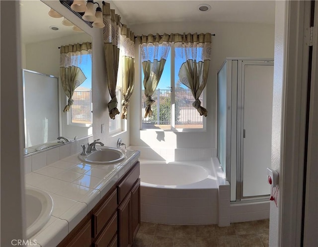 bathroom featuring plus walk in shower, tile patterned flooring, and vanity