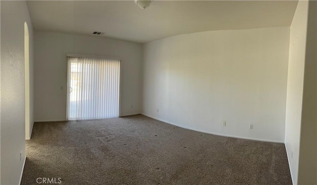 unfurnished room with dark carpet