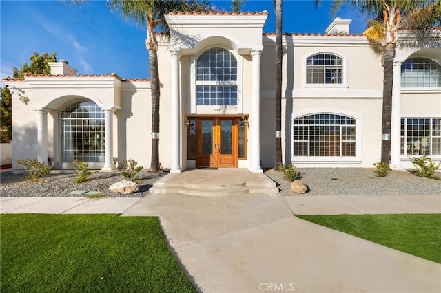 mediterranean / spanish home with french doors