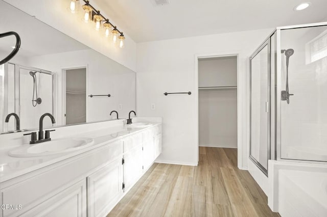 bathroom featuring vanity, wood-type flooring, and an enclosed shower