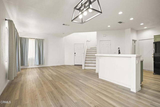 unfurnished living room featuring light hardwood / wood-style flooring