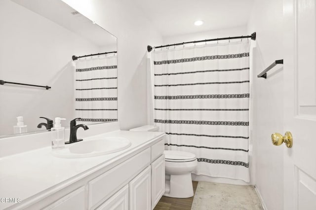 bathroom with curtained shower, toilet, and vanity