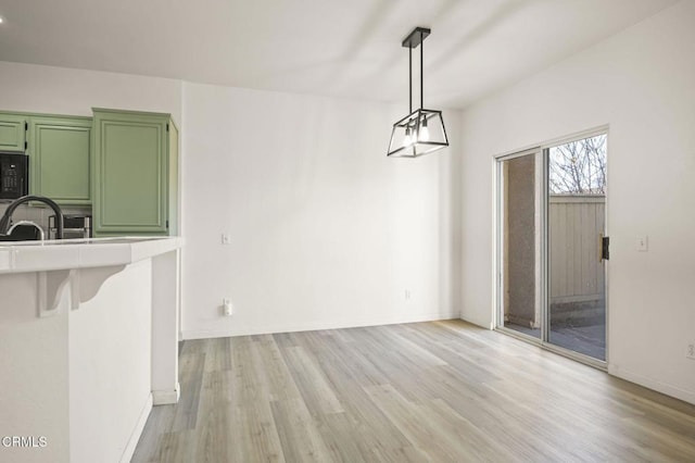 unfurnished dining area with light hardwood / wood-style floors