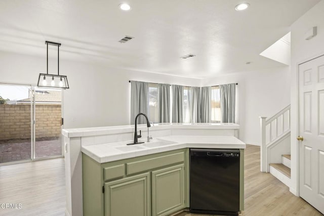 kitchen with tile countertops, black dishwasher, a kitchen island with sink, green cabinetry, and sink