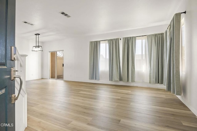 unfurnished living room with light wood-type flooring