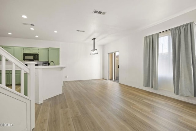 unfurnished living room featuring light hardwood / wood-style flooring