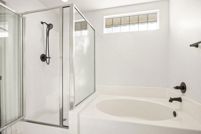 bathroom featuring separate shower and tub