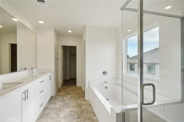 bathroom with plus walk in shower and vanity