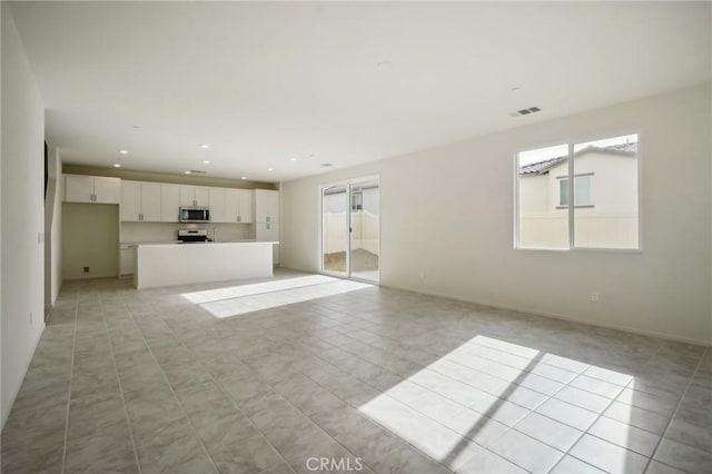 unfurnished living room featuring light tile patterned flooring