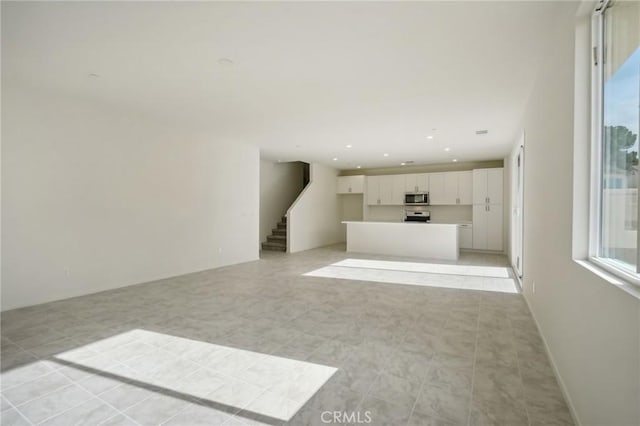 unfurnished living room featuring light tile patterned floors