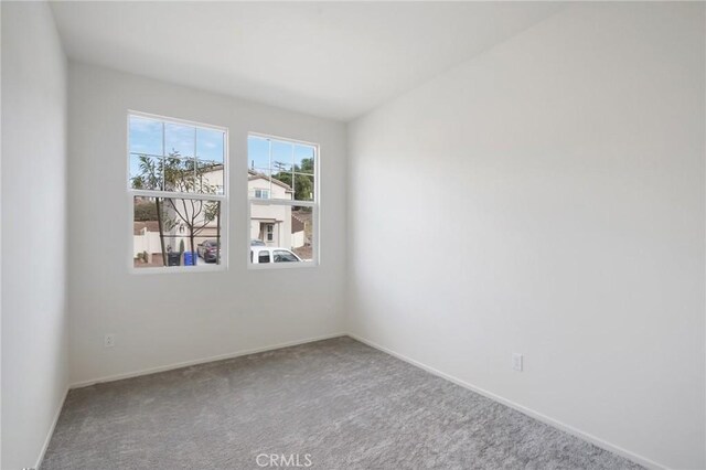 unfurnished room featuring carpet