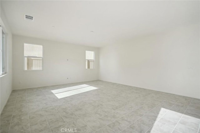 spare room featuring light tile patterned floors