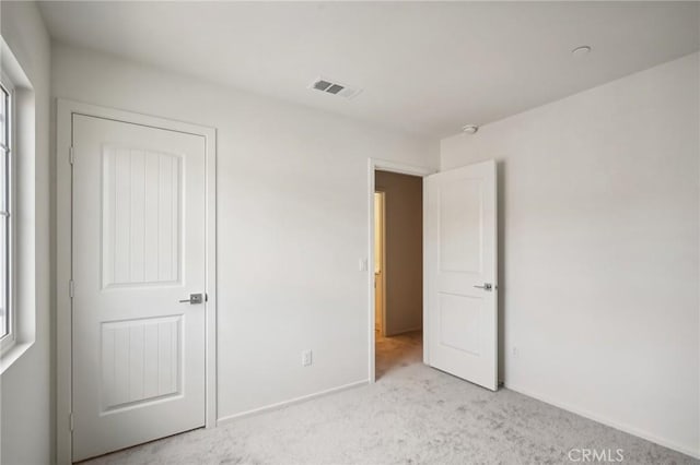 unfurnished bedroom with light carpet