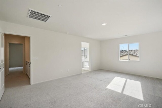 unfurnished room with light carpet