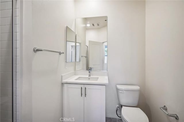 bathroom featuring toilet and vanity