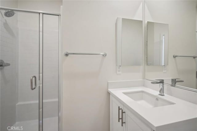 bathroom with an enclosed shower and vanity