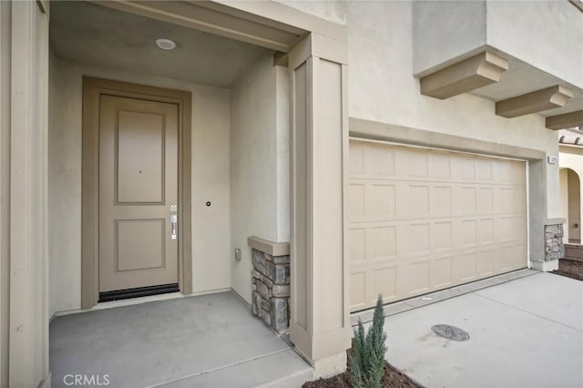 doorway to property with a garage