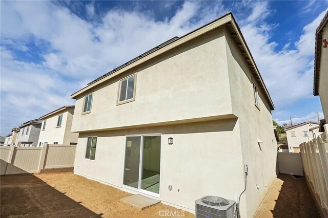 rear view of house featuring cooling unit