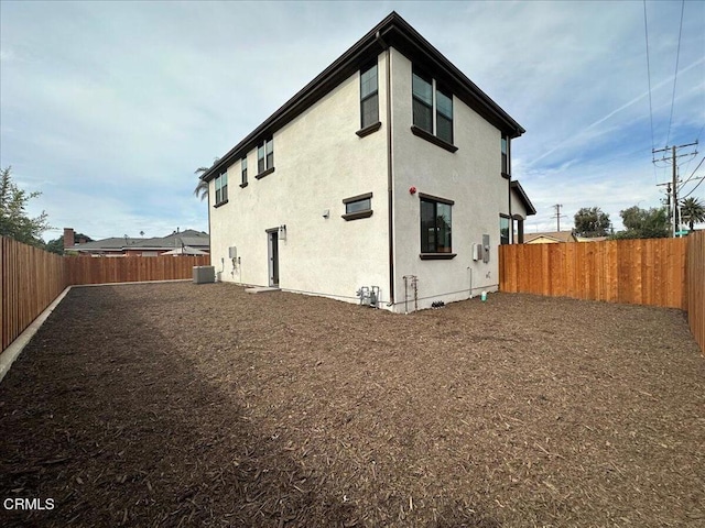 back of property featuring cooling unit