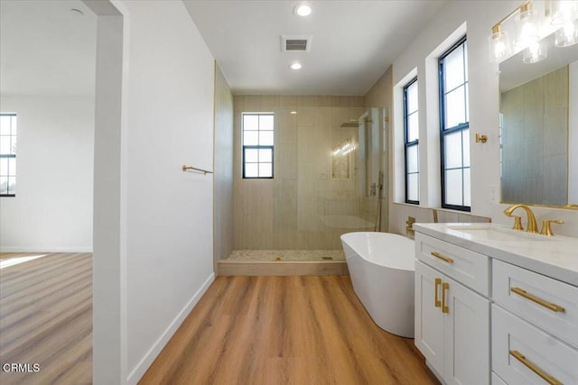 bathroom with vanity, wood-type flooring, and independent shower and bath