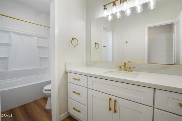 full bathroom featuring toilet, tub / shower combination, hardwood / wood-style flooring, and vanity