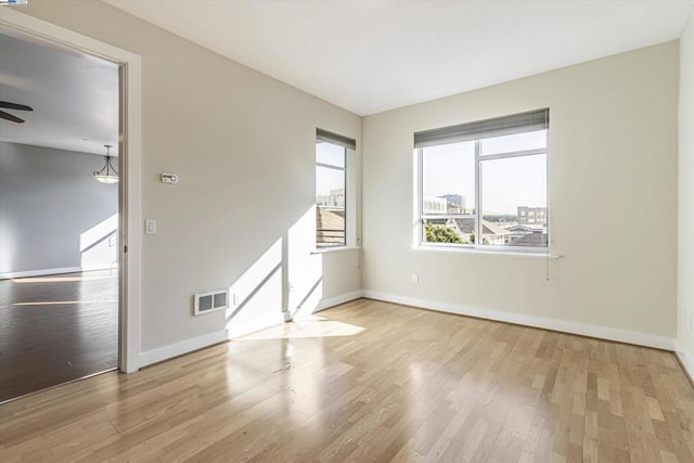 spare room featuring ceiling fan and light hardwood / wood-style floors