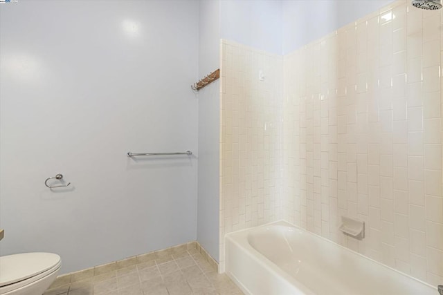 bathroom featuring toilet, shower / bath combination, and tile patterned flooring